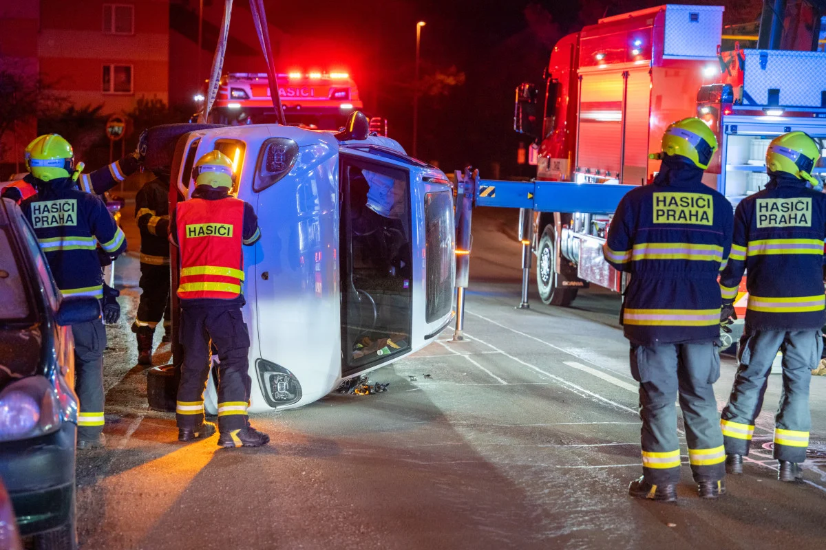 Porsche skončilo po večerní nehodě v Praze převrácené na boku